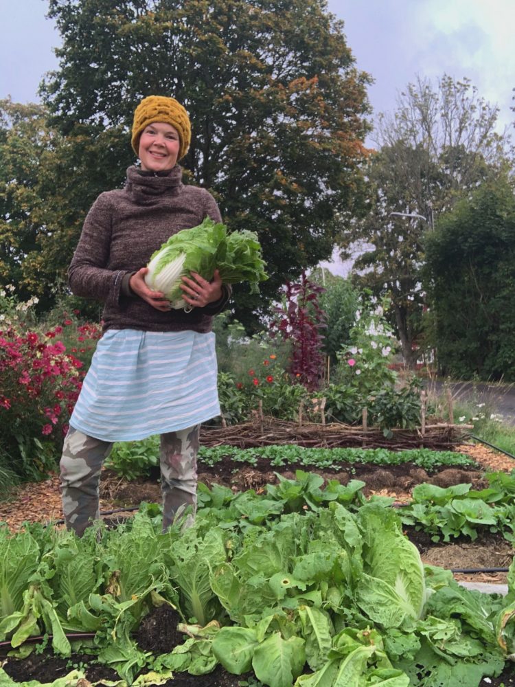 Sara with a napa cabbage in her arms.